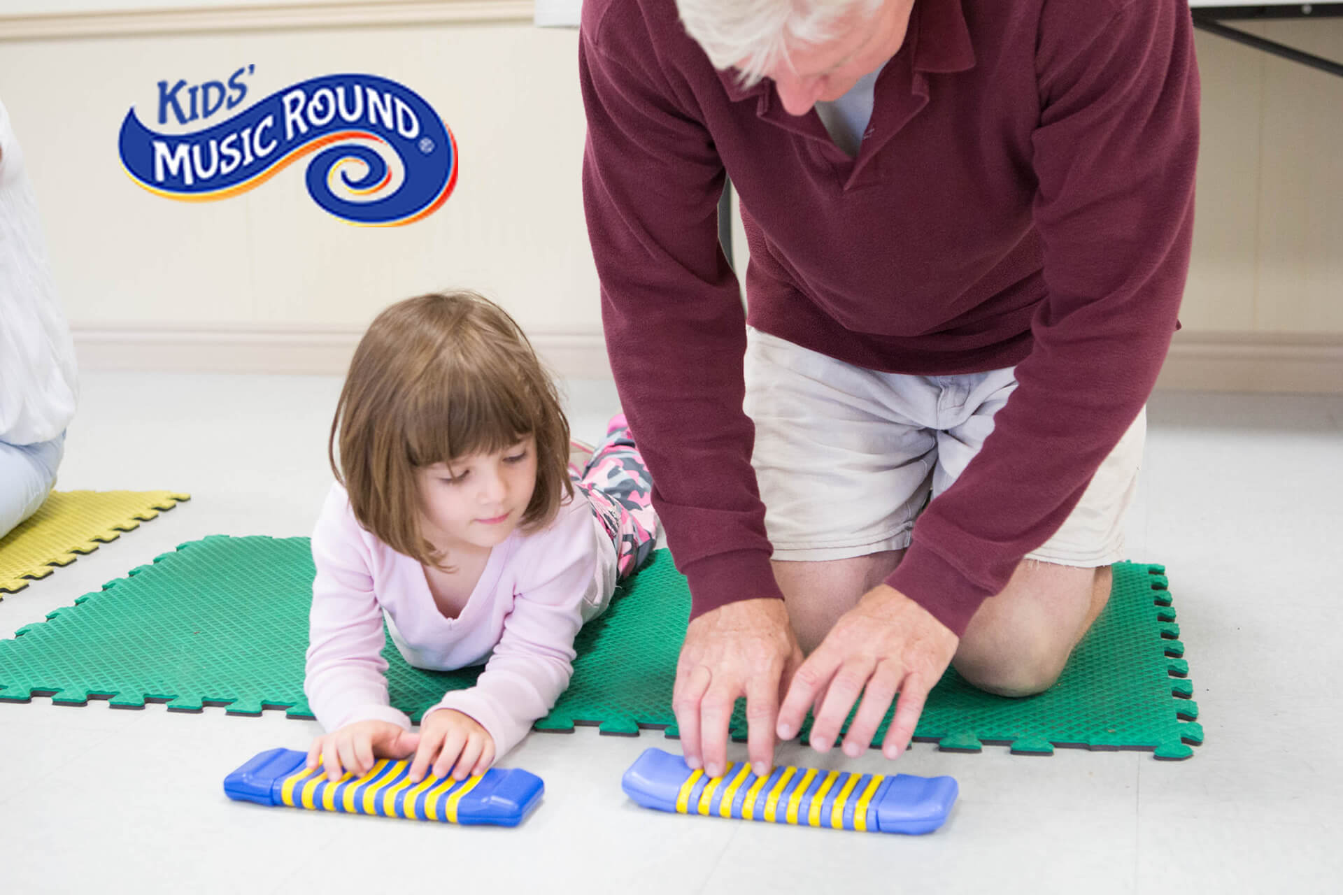 Child playing with a clatterpillar instrument