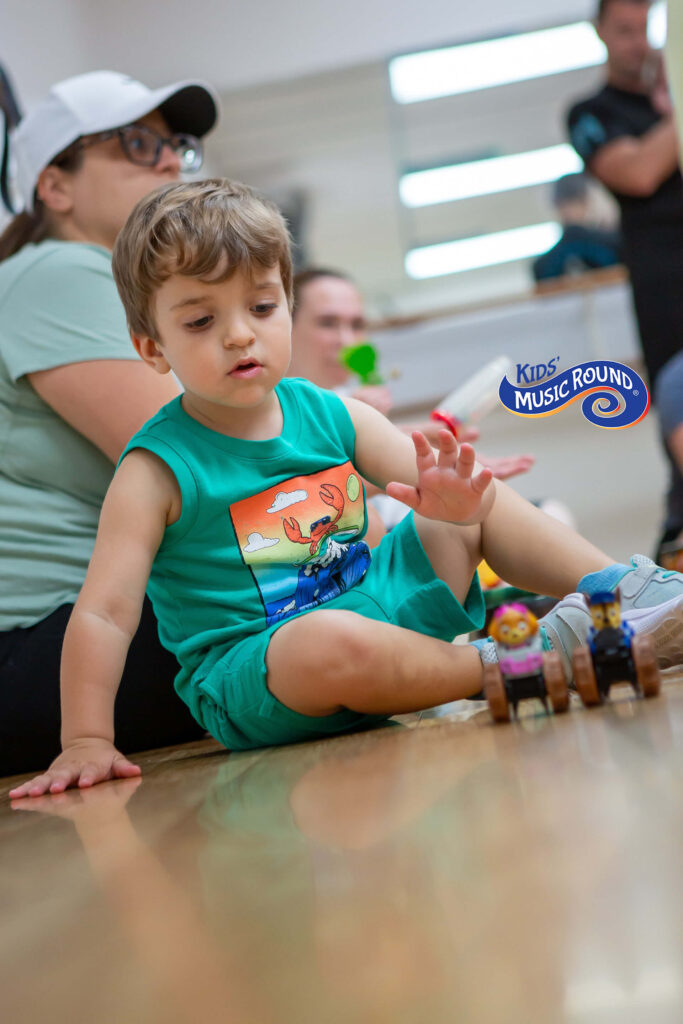 boy playing with musical toys