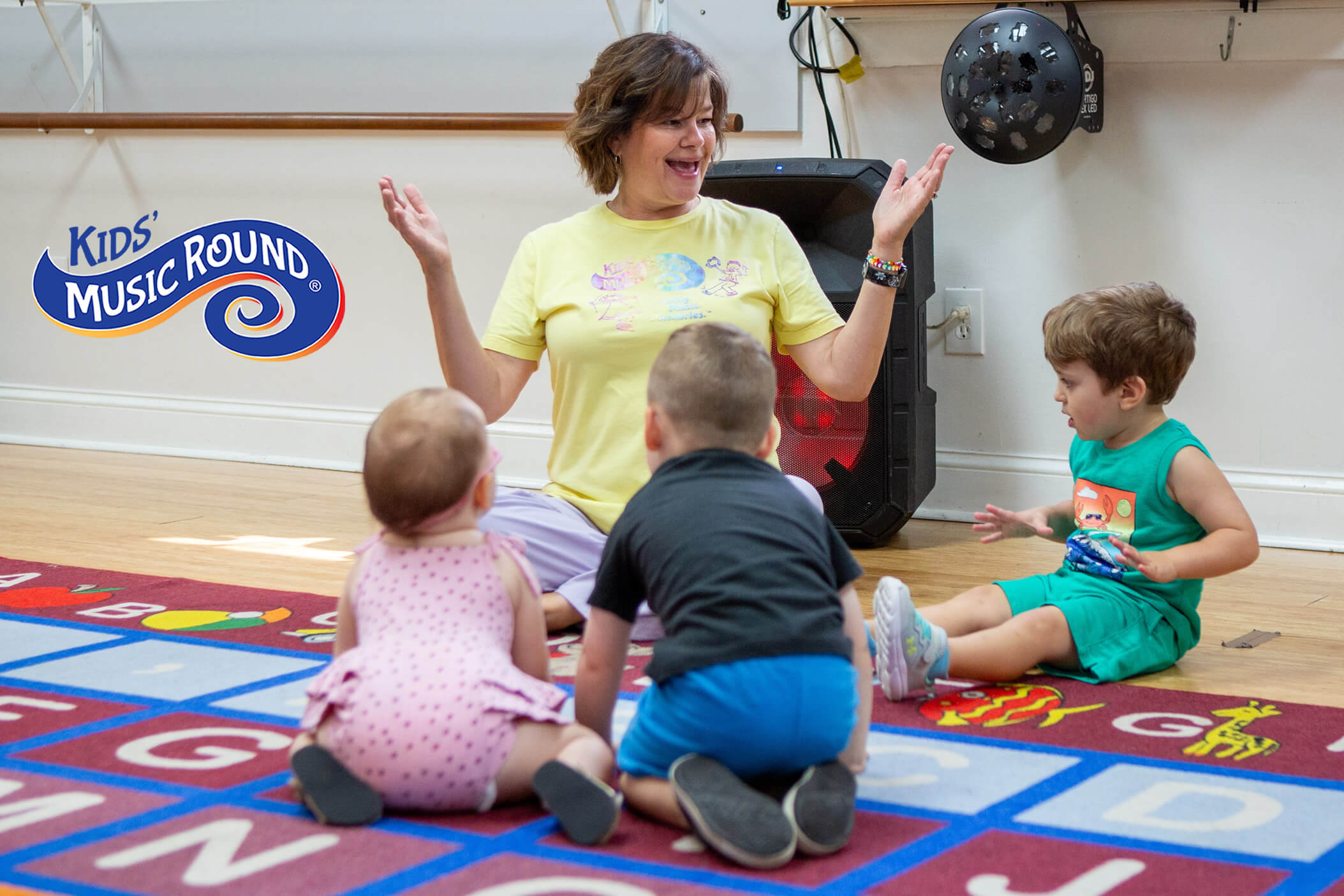 Teacher interacting with students on the rug
